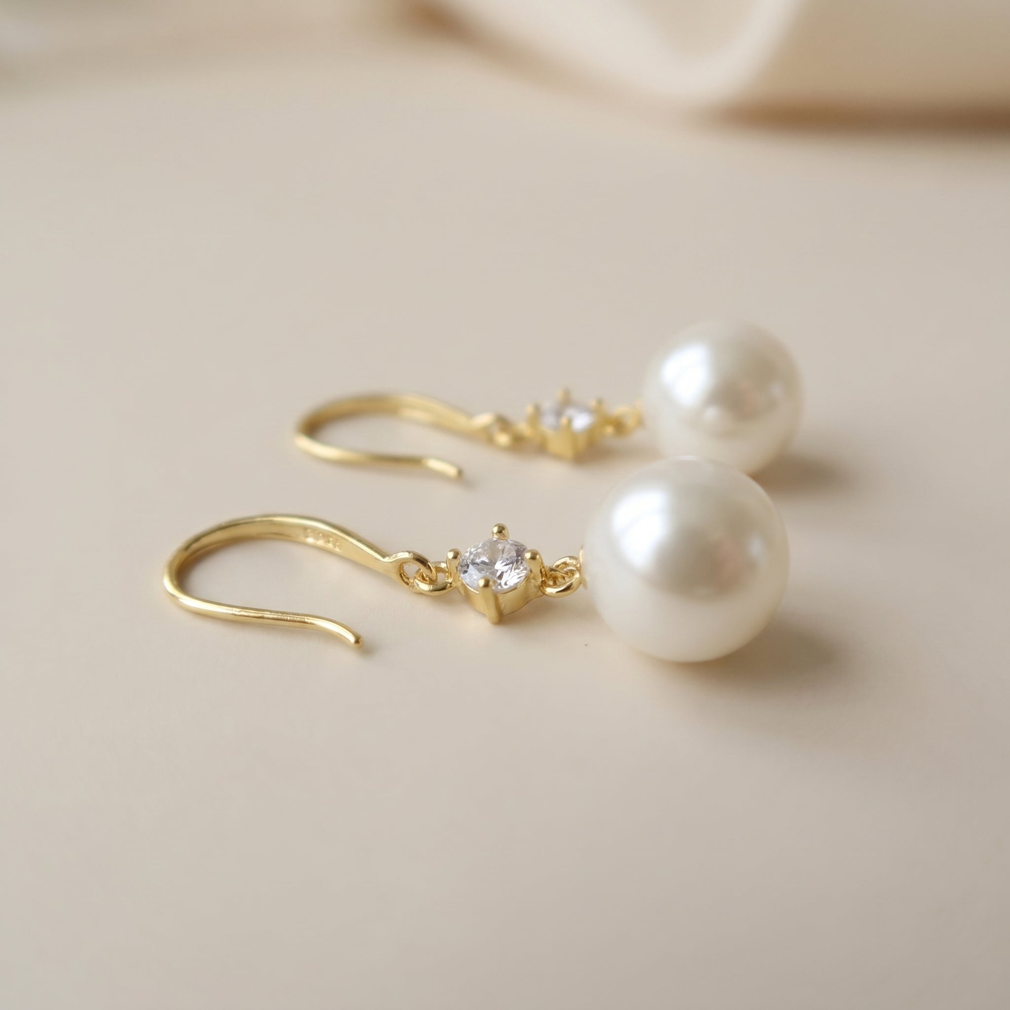 Close-Up of Gold Plated Sterling Silver Pearl Earrings with Sparkling Zirconia Detail