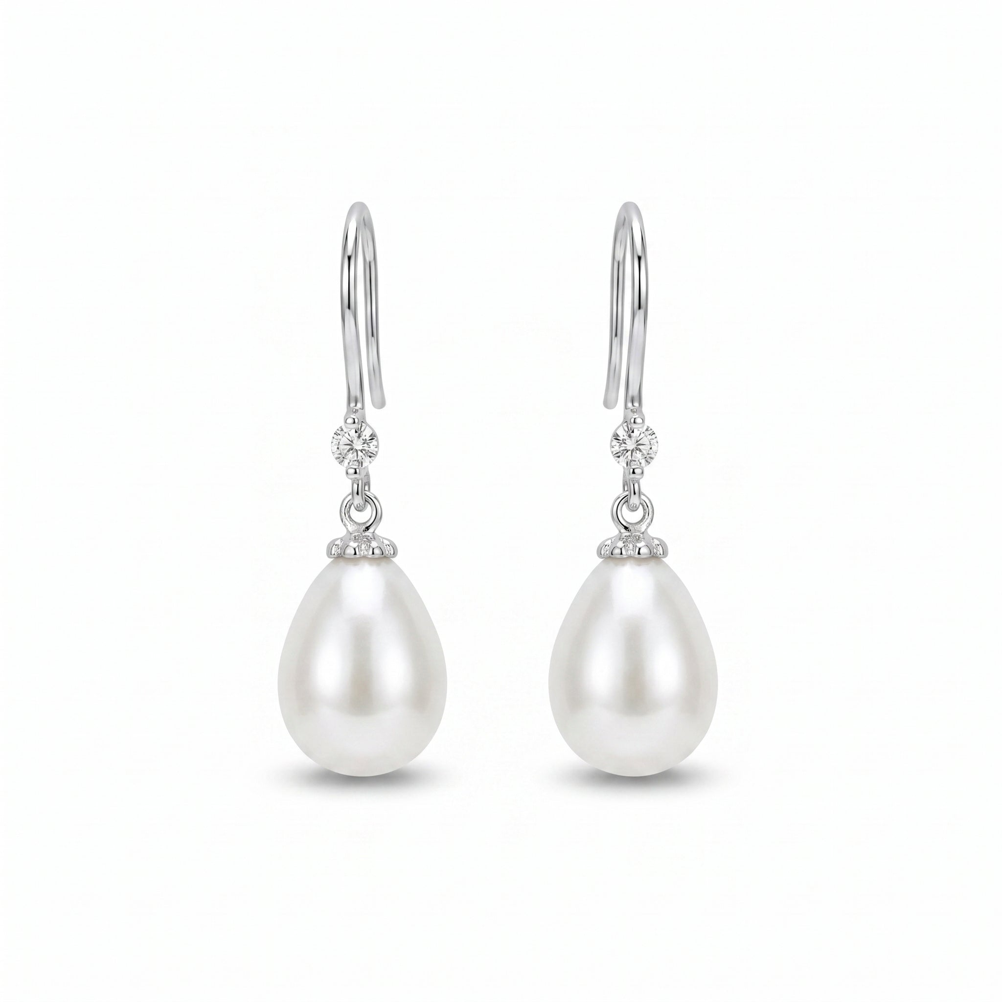Woman wearing 925 sterling silver freshwater pearl drop earrings with sparkling zirconia accents, elegant bridal jewellery for weddings and special occasions
